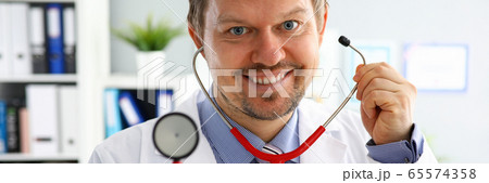 Handsome male doctor put on stethoscope portrait 65574358