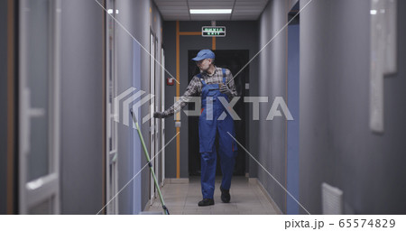 Janitor checking rooms in building 65574829