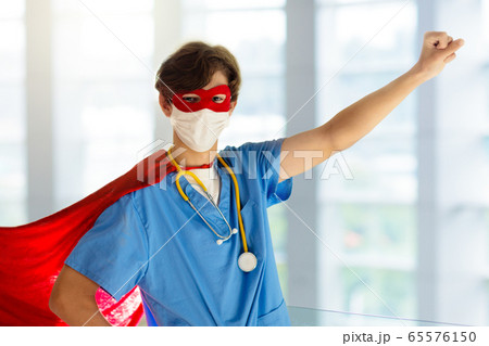 Doctor or nurse in face mask and superhero cape. Doctor or nurse in face mask and superhero cape. 65576150