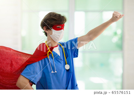 Doctor or nurse in face mask and superhero cape. 65576151