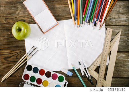 School stationery isolated on a wooden desk with copyspace 65576152