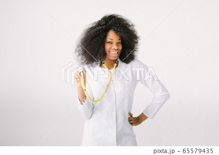 Young nurse portrait.Nurse, Healthcare And Medicine, Doctor. An African American female medical doctor with a stethoscope in hospital on white background Young nurse portrait.Nurse, Healthcare And Medicine, Doctor. An African American female medical doctor with a stethoscope in hospital on white background 65579435