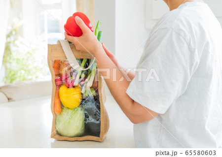 No face woman holding red bell paper from reusable 65580603