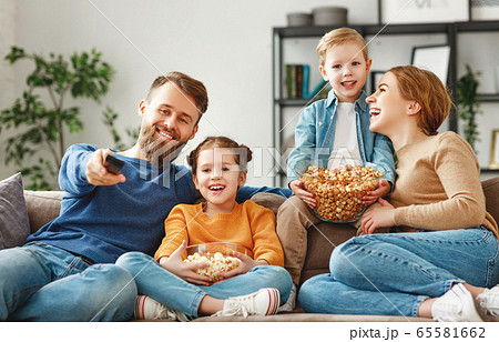Joyful family resting on sofa together. 65581662