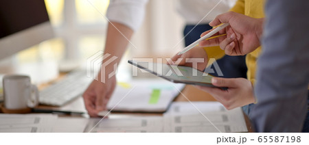 Side view of UI developer team brainstorming on Side view of UI developer team brainstorming on 65587198