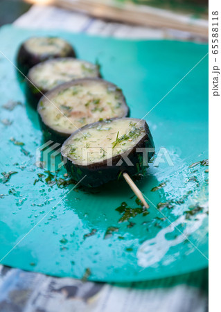 in a bowl, raw, struck eggplant in a marinade with herbs, dill in a rustic natural form. Preparation 65588118