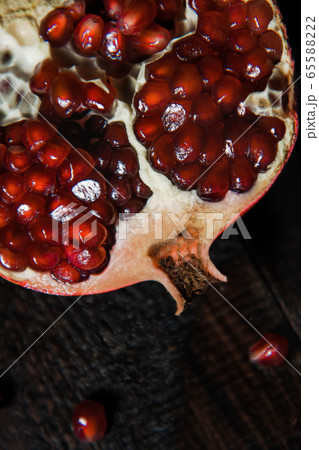 Broken pomegranate fruit on a dark background. close-up. view from above 65588222