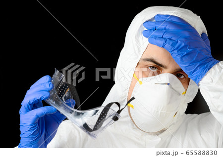COVID-19. Exhausted Doctor, in personal protective equipment, worried as the coronavirus infected 65588830