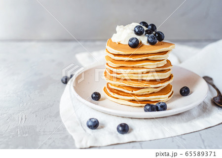 Stack of pancakes with fresh blueberry. Stack of pancakes with fresh blueberry. 65589371