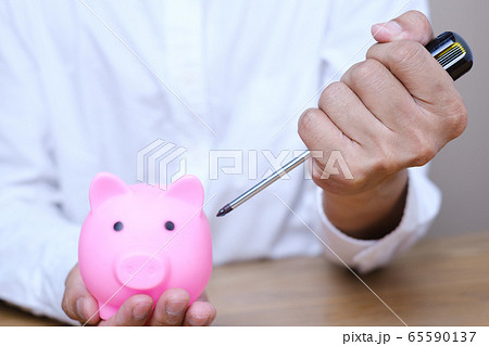Emergency finance and Reserve money concept, Businessman using tools to destroy pink piggy bank 65590137