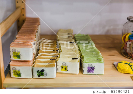 Natural handmade soap on shelves of zero waste shop reuse cotton pads Natural handmade soap on shelves of zero waste shop reuse cotton pads 65590421