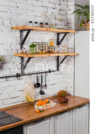 interior of modern kitchen white brick wall zero waste concept glass jars mesh reuse bag 65590547