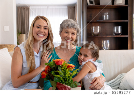 Senior Caucasian woman spending time with her daughter and her granddaughter at home Senior Caucasian woman spending time with her daughter and her granddaughter at home 65595277