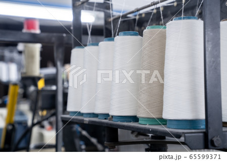 interior of textile factory.Yarn manufacturing.Industrial concept. interior of textile factory.Yarn manufacturing.Industrial concept. 65599371