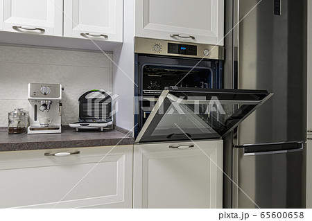 Electric appliances in minimalistic white kitchen interior Electric appliances in minimalistic white kitchen interior 65600658