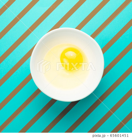 Raw egg in bowl. Minimal creative idea concept. Raw egg in bowl. Minimal creative idea concept. 65601451