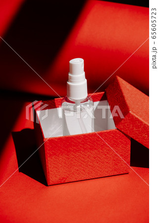 Post-Covid New Normal concept with Alcohol hand Sanitizing Spray as gift in red gift box. How Will Things Change In Post Pandemic World Post-Covid New Normal concept with Alcohol hand Sanitizing Spray as gift in red gift box. How Will Things Change In Post Pandemic World 65605723