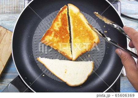 Chef baking parmesan cheese toast by pan Chef baking parmesan cheese toast by pan 65606369