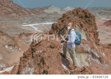 Backpacker in facial mask, tourist season 2020. Backpacker in facial mask, tourist season 2020. 65606726