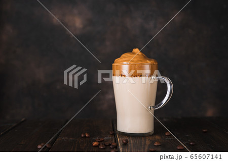 A glass cup of whipped instant coffee Dalgona on A glass cup of whipped instant coffee Dalgona on 65607141