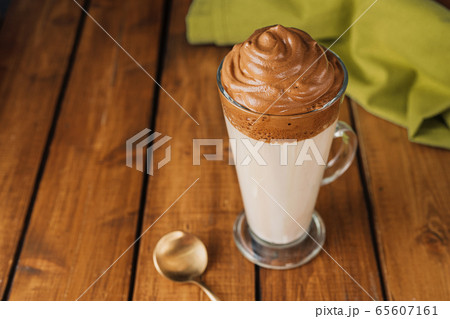 A long glass of delicious whipped Dalgona Coffee A long glass of delicious whipped Dalgona Coffee 65607161