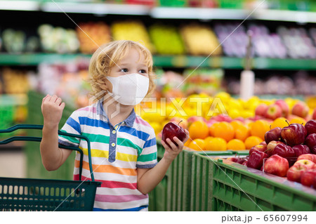 Child in supermarket. Kid grocery shopping. 65607994