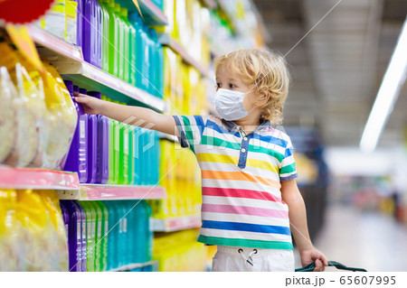 Child in supermarket. Kid grocery shopping. 65607995