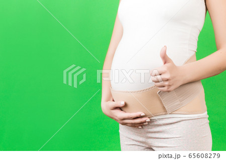 Close up of pregnant woman showing thumb up and Close up of pregnant woman showing thumb up and 65608279