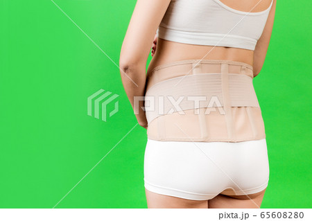 Back view of pregnant woman in underwear wearing Back view of pregnant woman in underwear wearing 65608280