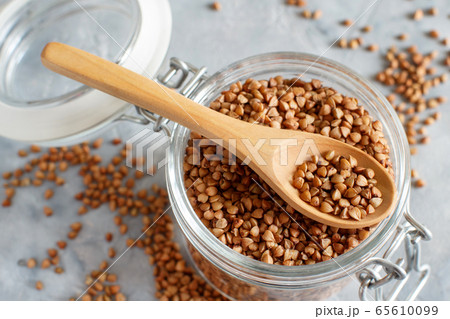Raw dry buckwheat grain in a jar with a spoon Raw dry buckwheat grain in a jar with a spoon 65610099