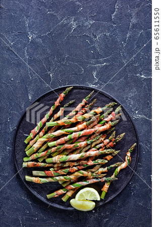 Spring asparagus wrapped in bacon, copy space 65611550