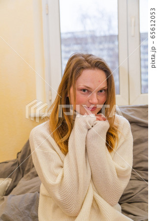 Portrait of beautiful woman in white warm sweater Portrait of beautiful woman in white warm sweater 65612053