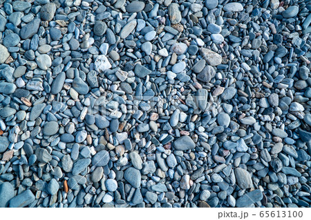 Blue pebbles. Background from a natural stone of blue, turquoise hue. Pebbles texture 65613100