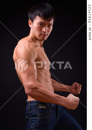 Portrait of young muscular Asian man shirtless ready to fight Portrait of young muscular Asian man shirtless ready to fight 65614523
