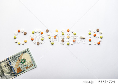 covid-19 inscription with pills and capsules and 100 dollar bill in layout on a white background copy space. Coronavirus, medicine and health, safety concept. covid-19 inscription with pills and capsules and 100 dollar bill in layout on a white background copy space. Coronavirus, medicine and health, safety concept. 65614724
