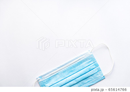 Medical blue disposable protective mask on a white background copy space. A surgical dressing closes the mouth and nose. Healthcare, medicine, covid-19, epidemic concept. Medical blue disposable protective mask on a white background copy space. A surgical dressing closes the mouth and nose. Healthcare, medicine, covid-19, epidemic concept. 65614766