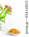 Trendy pancake cereal meal and flowers on background. Tiny baked pancakes. Breakfast food. 65614853