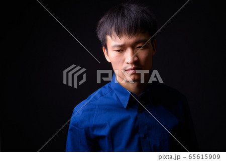 Portrait of young Asian businessman thinking and looking away 65615909
