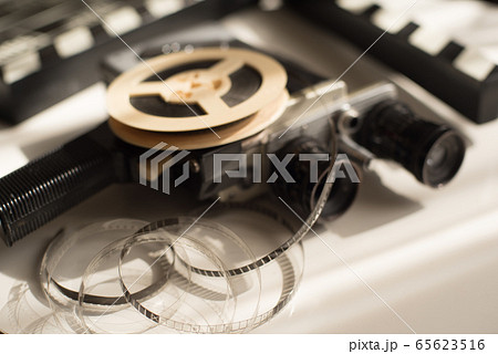 Film roll with movie camera and movie clapper 65623516