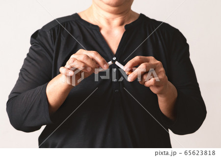 Quit smoking, no tobacco day, mother hands breaking the cigarette 65623818