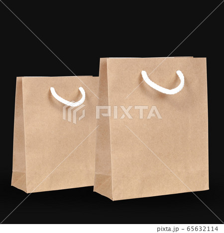 Brown paper shopping bags on black background. Brown paper shopping bags on black background. 65632114
