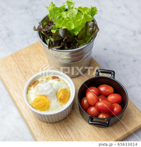 Frying pan with tasty eggs on table Frying pan with tasty eggs on table 65633014