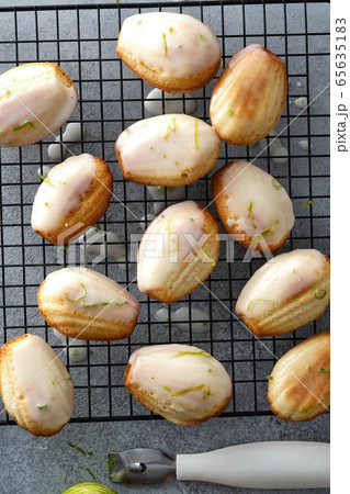 Handmade madeleine on cooling rack, traditional french small cake cookie on gray table Handmade madeleine on cooling rack, traditional french small cake cookie on gray table 65635183
