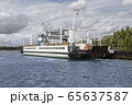 Ferry with cars floating across the river 65637587
