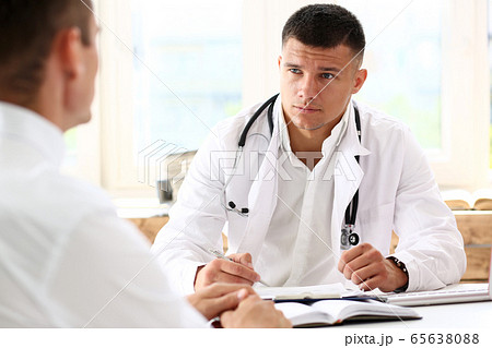 Handsome smiling male doctor hold silver pen 65638088