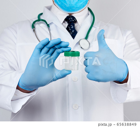 doctor in a white coat and blue sterile latex 65638849