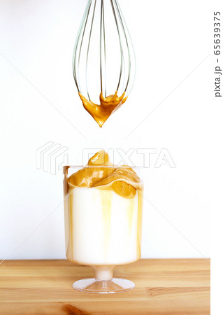 Dalgona coffee in transparent glass. Copy space. 65639375