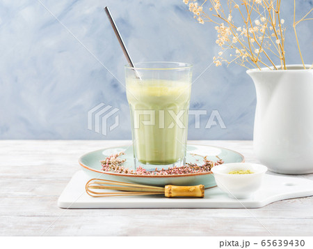 Green matcha tea latte drink in tall glass Green matcha tea latte drink in tall glass 65639430