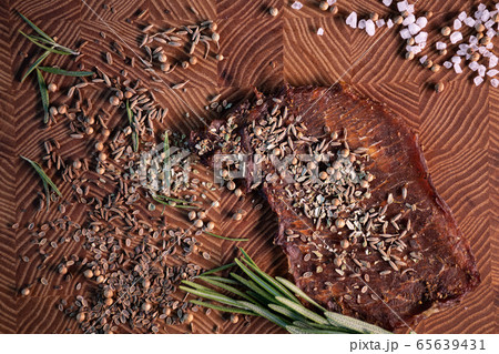 Close-up of a piece of meat on a wooden Board with spices. Restaurant menu, a series of photos of different dishes 65639431