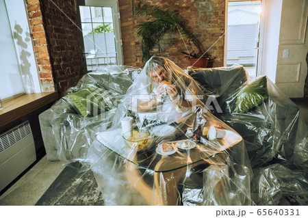 Senior man covered with plastic, eating fast food and drinking beer - environmental pollution by people concept 65640331